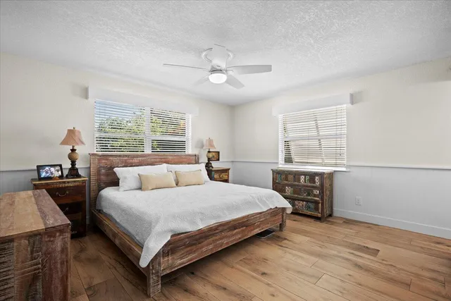 a bedroom with a large bed and a chandelier