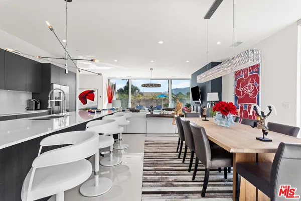 a kitchen with a dining table and chairs