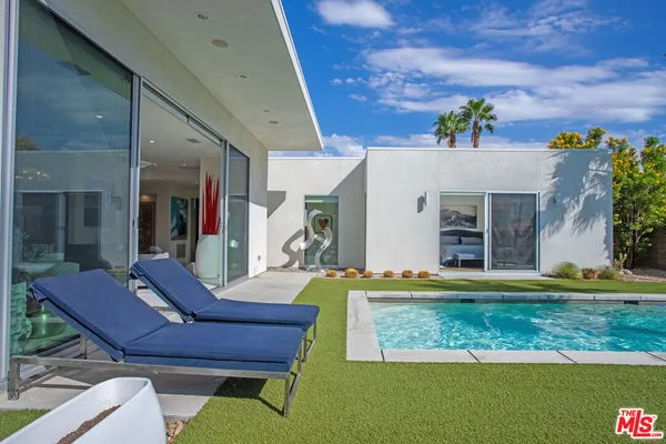 a view of a house with swimming pool and a yard
