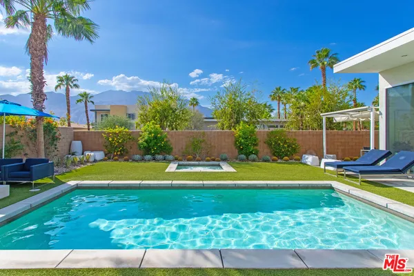 a view of swimming pool with seating area and furniture