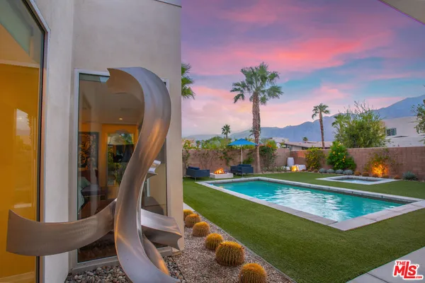 swimming pool view with a seating space and a garden view
