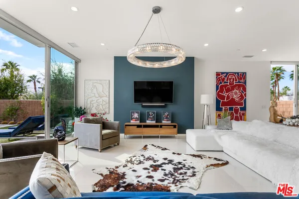 a kitchen with stainless steel appliances a sink a stove and a wooden floors