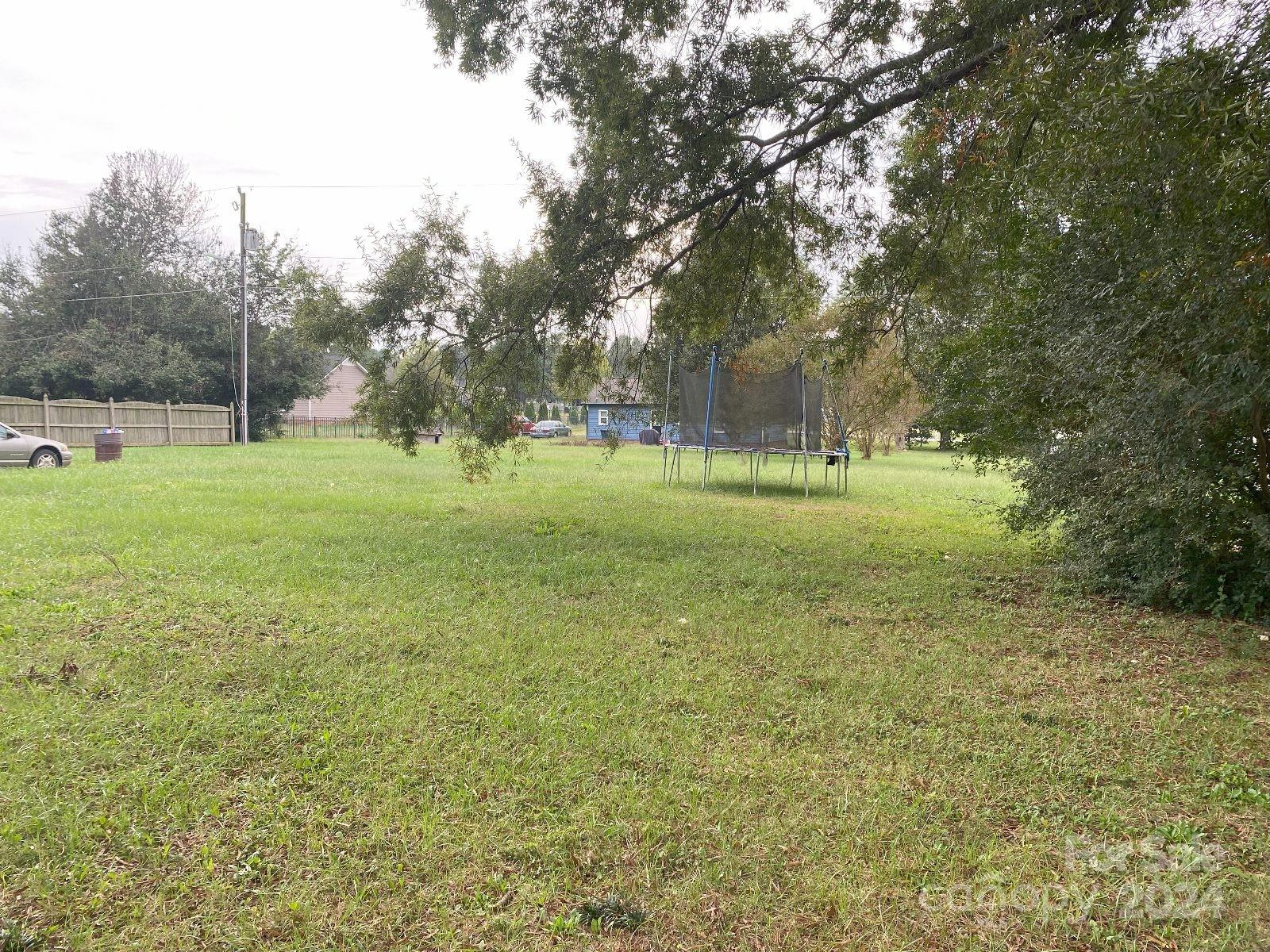 716 Edgehill Drive Monroe, NC 28110 - Photo 6 of 22 a view of a big yard with a trees
