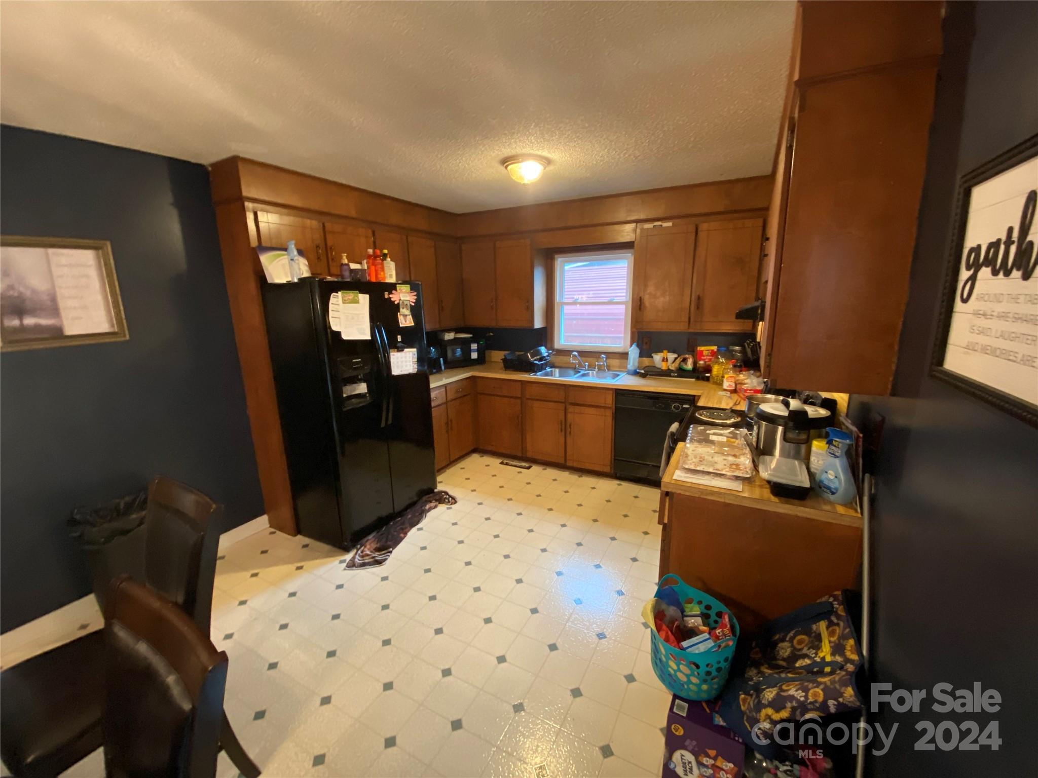 716 Edgehill Drive Monroe, NC 28110 - Photo 9 of 22 a kitchen with granite countertop a sink stove and refrigerator
