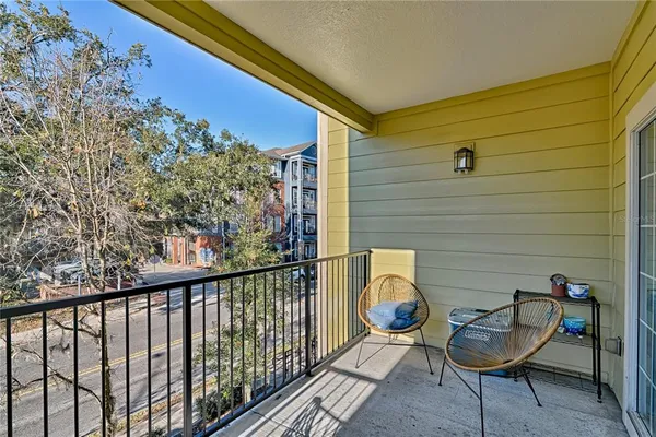 a view of a chair and tables in the balcony