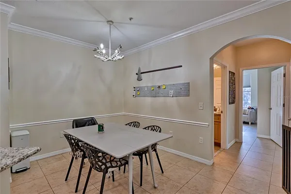 a view of a dining room with furniture and chandelier