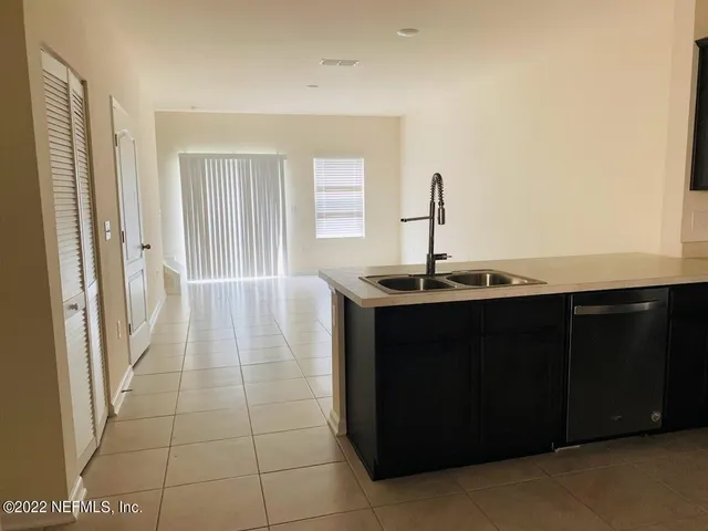 a kitchen with a sink and a mirror
