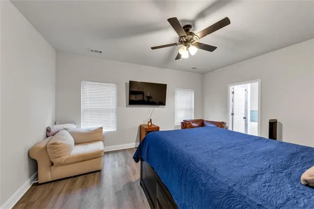 a bedroom with a large bed and a flat screen tv