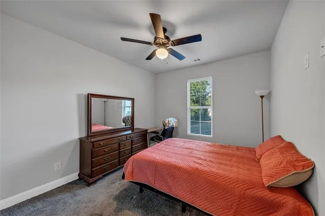 a bedroom with a bed dresser and a window