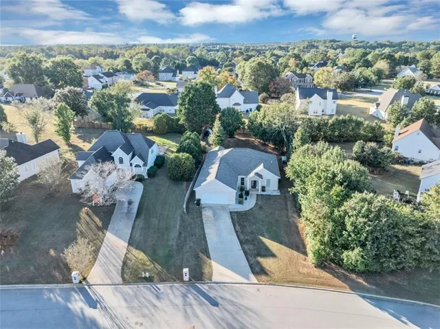 an aerial view of a house with garden space and street view