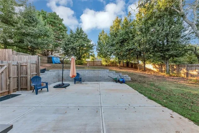 a backyard of a house with table and chairs