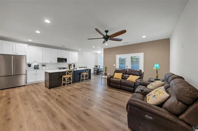 a living room kitchen with furniture and kitchen view