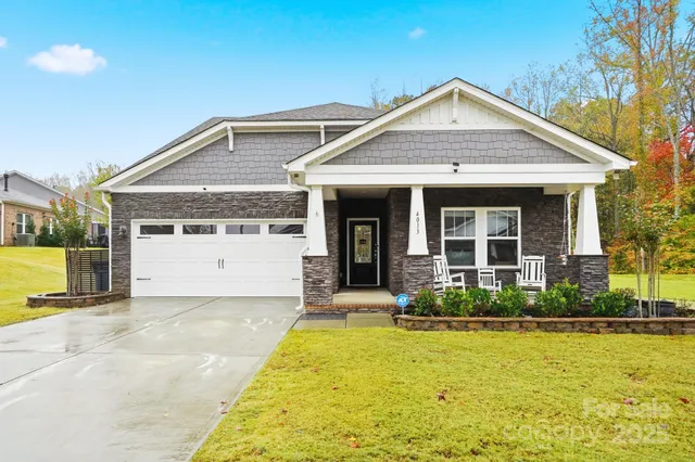 a front view of a house with swimming pool and glass windows