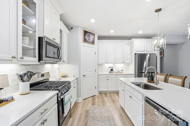 a kitchen that has a lot of cabinets in it