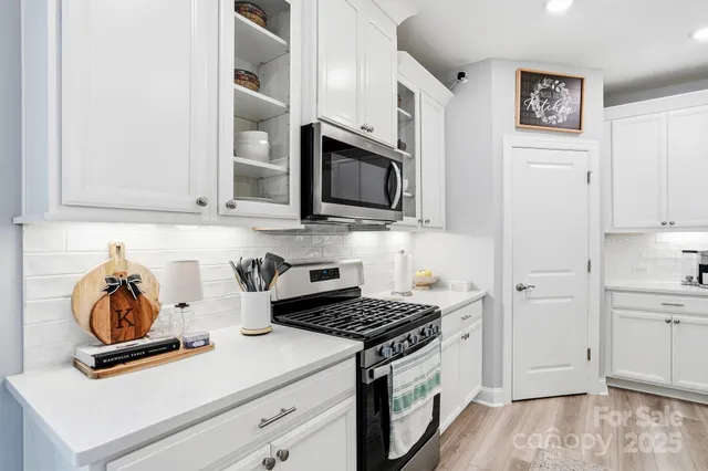 a view of a dining room with furniture large windows and wooden floor
