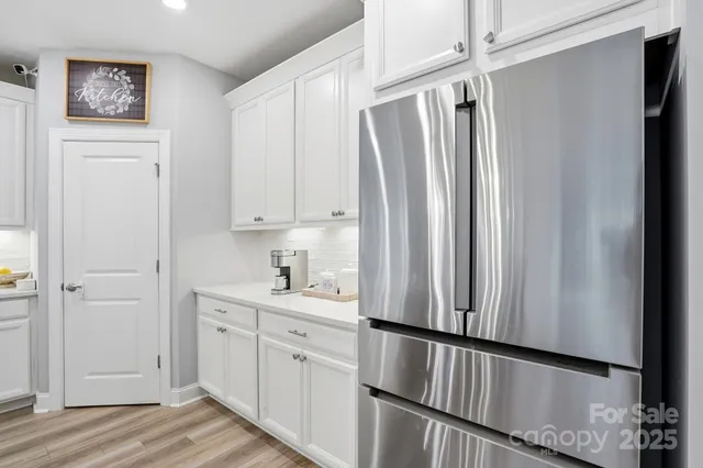 a dining room with furniture a chandelier and window