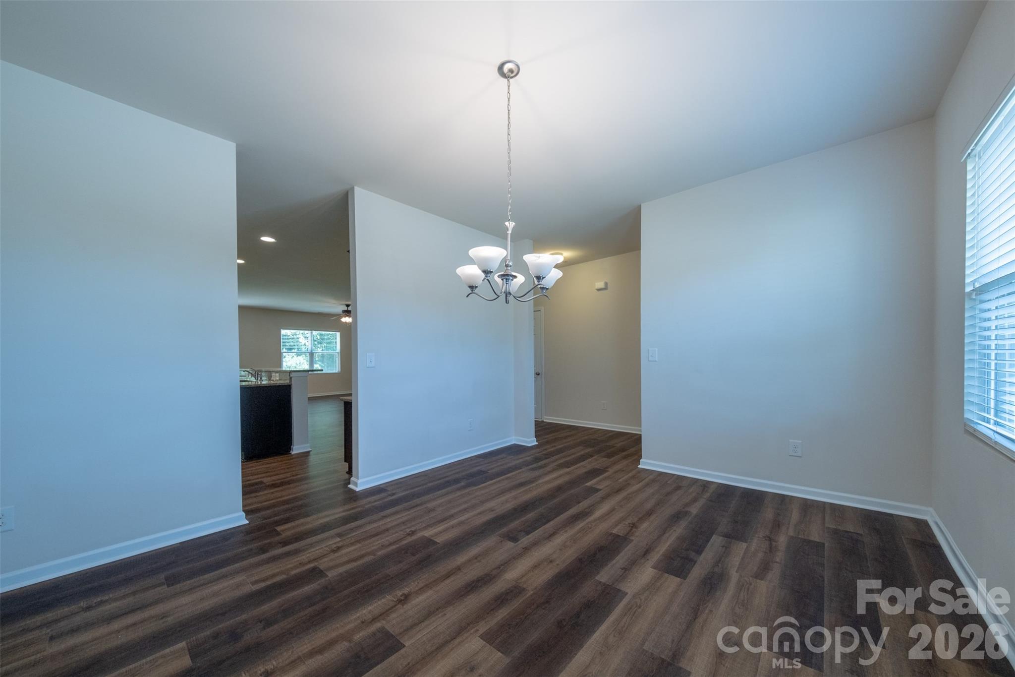 3006 Houndscroft Road Indian Trail, NC 28079 - Photo 7 of 39 a view of a room with a chandelier fan and wooden floor
