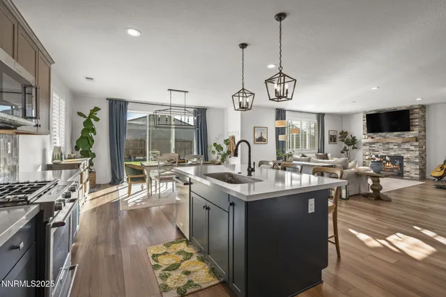 a kitchen with stainless steel appliances granite countertop a stove and cabinets