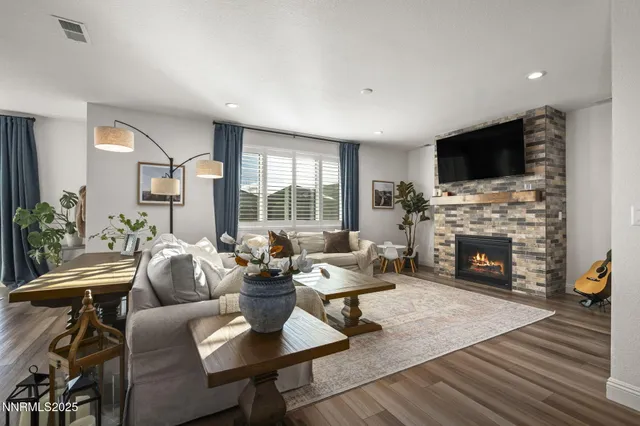 a living room with furniture a flat screen tv and a fireplace