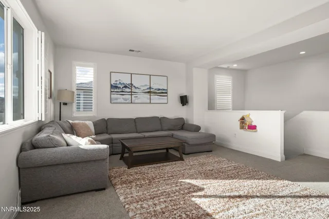 a living room with furniture and windows