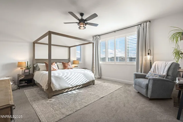 a spacious bedroom with a bed a couch and a window