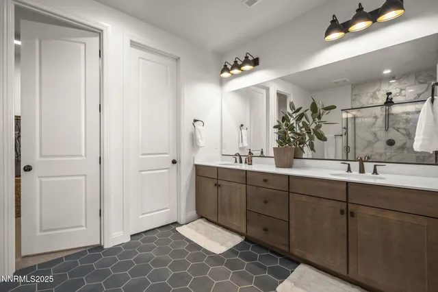 a spacious bathroom with a double vanity sink mirror and