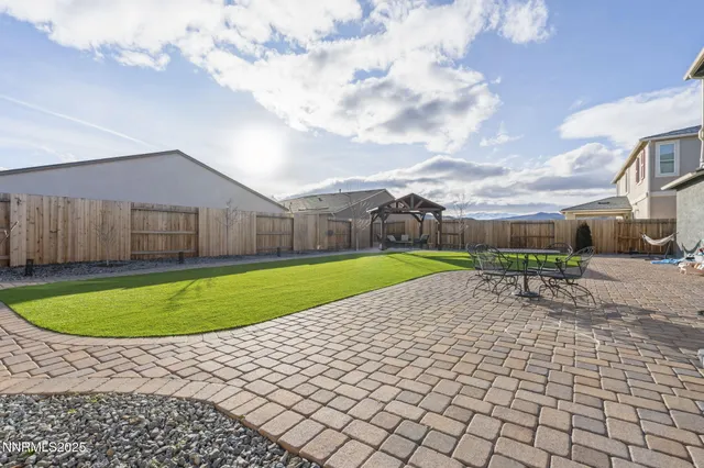 a view of a backyard with swimming pool