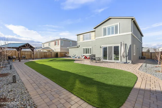 a front view of a house with a yard table and chairs