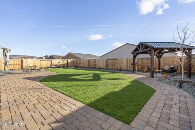 a house view with swimming pool in front of it