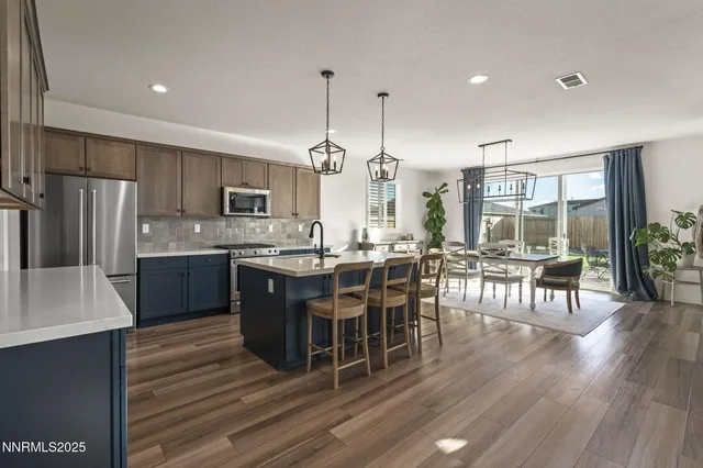 a large kitchen with a table and chairs