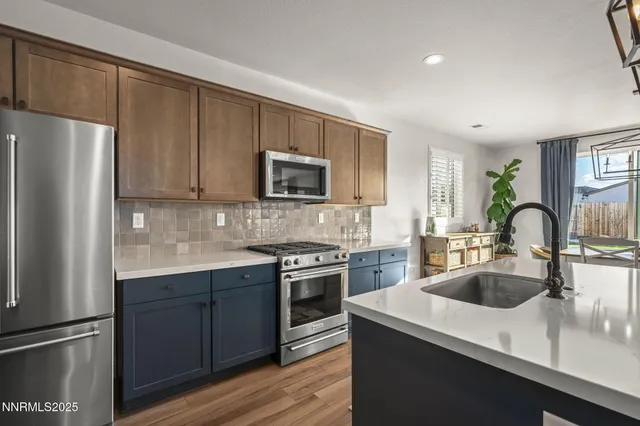 a kitchen with a sink a refrigerator and cabinets