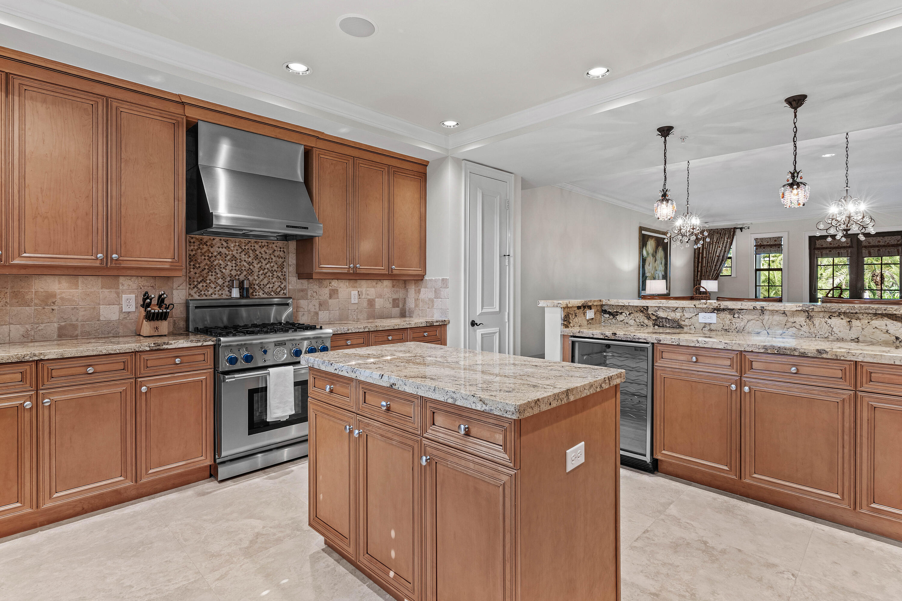 110 Gleason Street, Unit 203 Delray Beach, FL 33483 - Photo 3 of 25 a kitchen that has a sink a stove and chairs