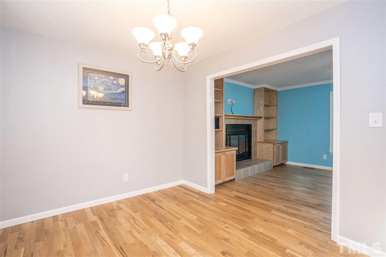 7300 Mine Shaft Road Raleigh, NC 27615 - Photo 12 of 22 a view of empty room with wooden floor and fireplace