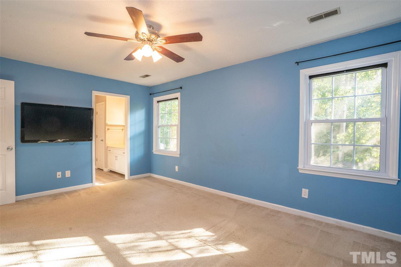 7300 Mine Shaft Road Raleigh, NC 27615 - Photo 14 of 22 a view of a livingroom with a ceiling fan and window