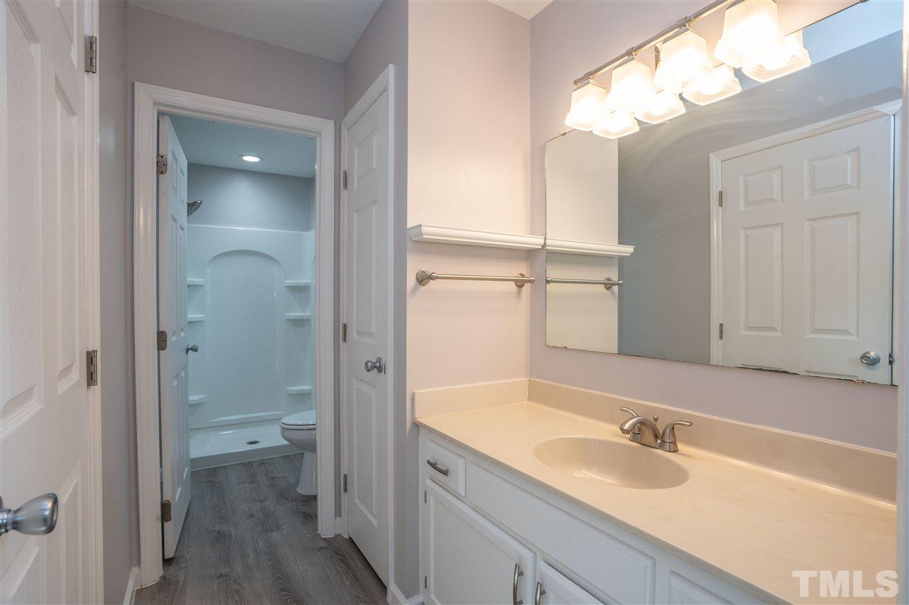 7300 Mine Shaft Road Raleigh, NC 27615 - Photo 15 of 22 a bathroom with a granite countertop sink mirror and a toilet