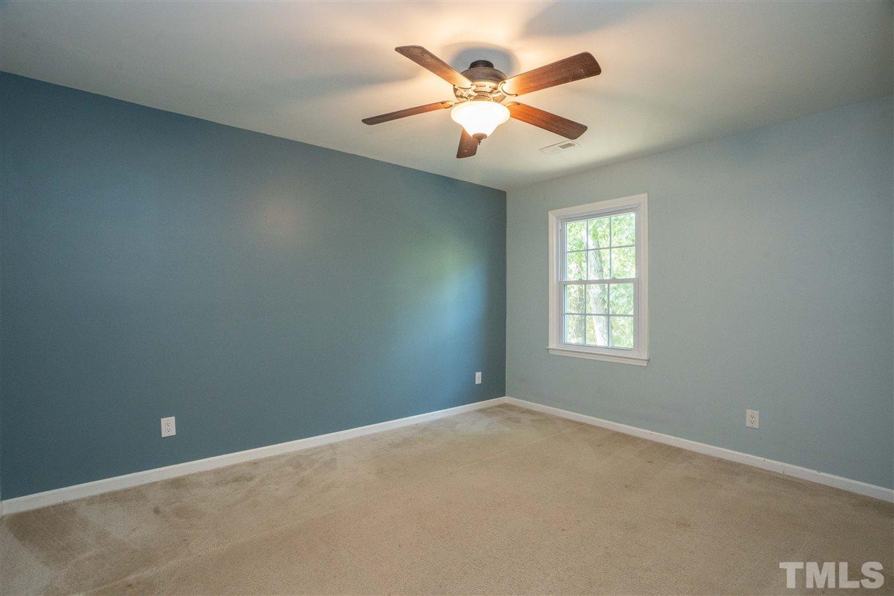 7300 Mine Shaft Road Raleigh, NC 27615 - Photo 17 of 22 an empty room with ceiling fan and window