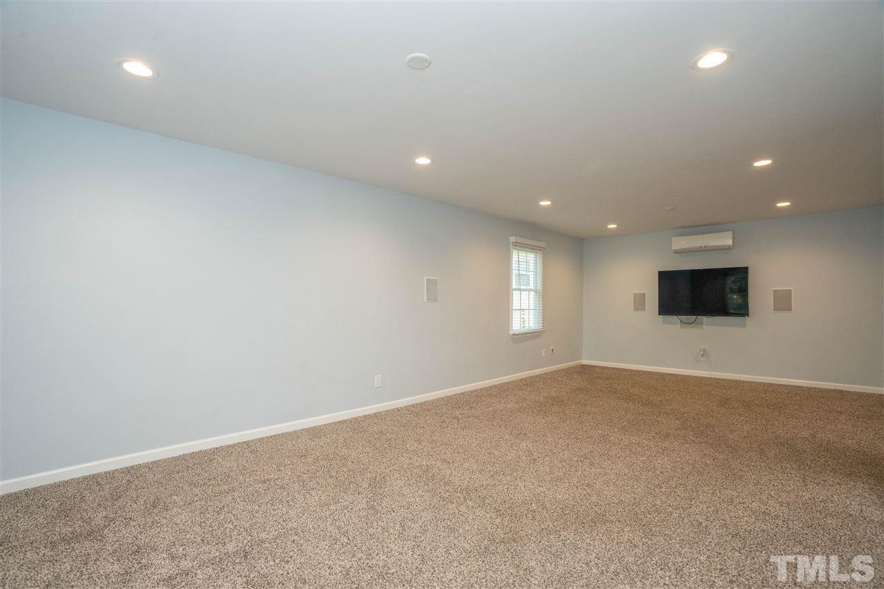 7300 Mine Shaft Road Raleigh, NC 27615 - Photo 19 of 22 an empty room with windows and fireplace