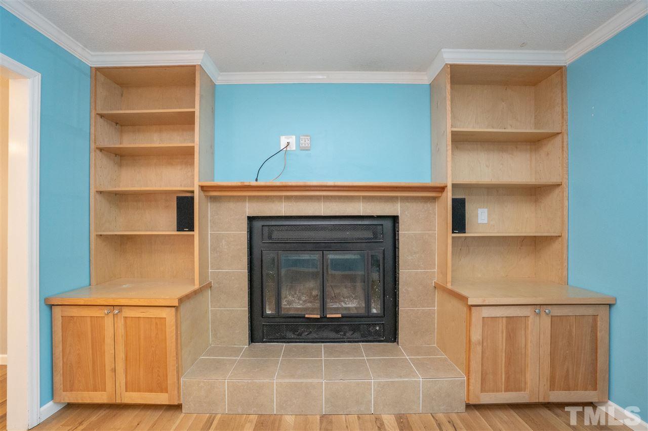 7300 Mine Shaft Road Raleigh, NC 27615 - Photo 5 of 22 a living room with a fireplace cabinet and a fireplace