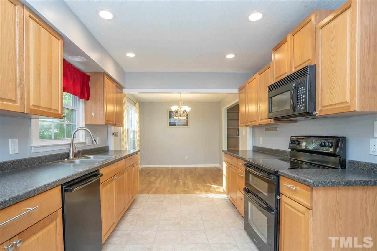 7300 Mine Shaft Road Raleigh, NC 27615 - Photo 7 of 22 a kitchen with stainless steel appliances granite countertop a sink stove and cabinets
