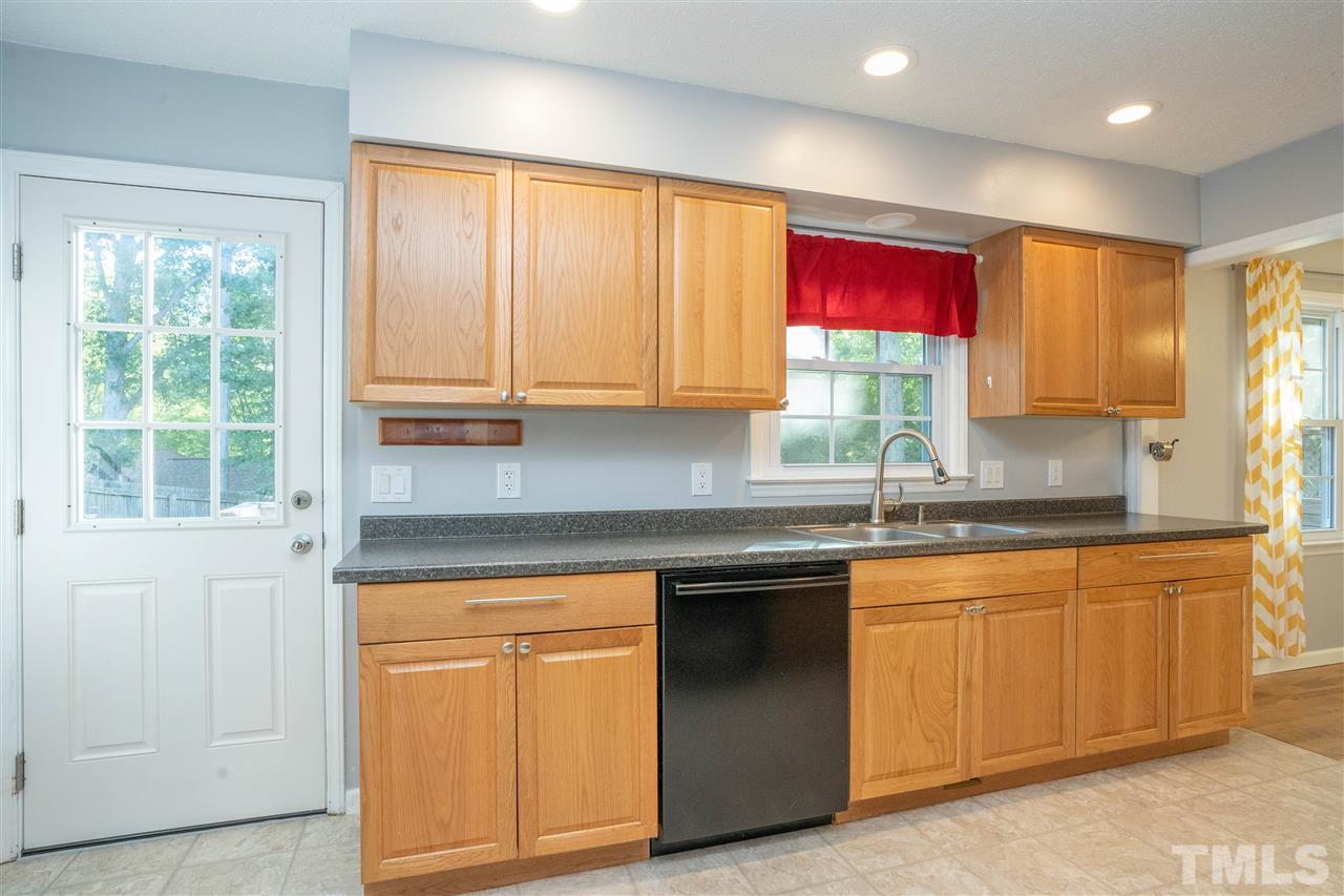 7300 Mine Shaft Road Raleigh, NC 27615 - Photo 8 of 22 a kitchen with stainless steel appliances granite countertop a stove a sink and a microwave
