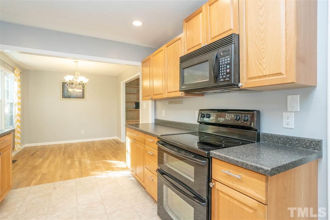 7300 Mine Shaft Road Raleigh, NC 27615 - Photo 9 of 22 a kitchen with granite countertop cabinets stainless steel appliances and a counter space