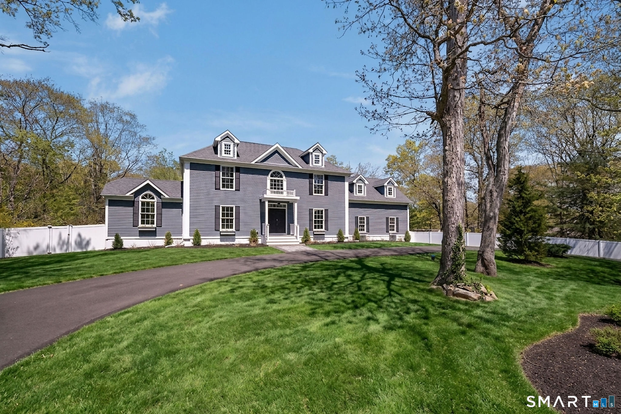 9 Sunset Ridge Drive Guilford, CT 06437 - Photo 1 of 40 a front view of a house with yard and green space