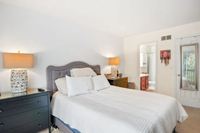 a bedroom with a bed and a night stand