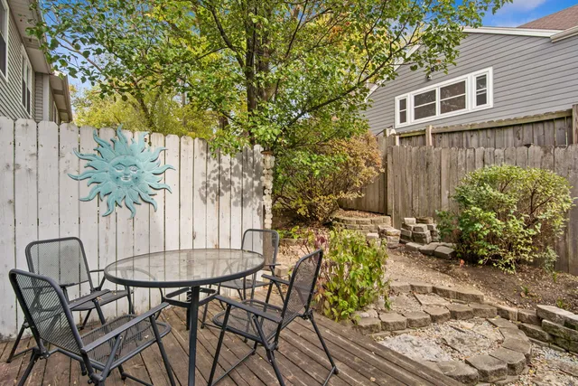 a view of a chairs and table in the backyard