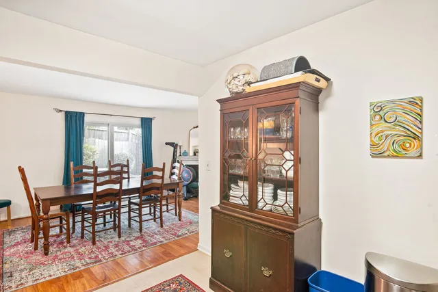 a view of a dining room with furniture wooden floor and a floor to ceiling window