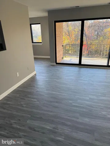 a view of a room with wooden floor and window