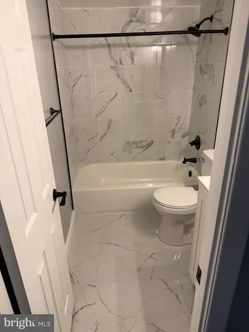 a bathroom with a shower a toilet and a shower