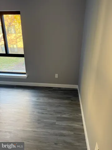 a view of room with window and wooden floor