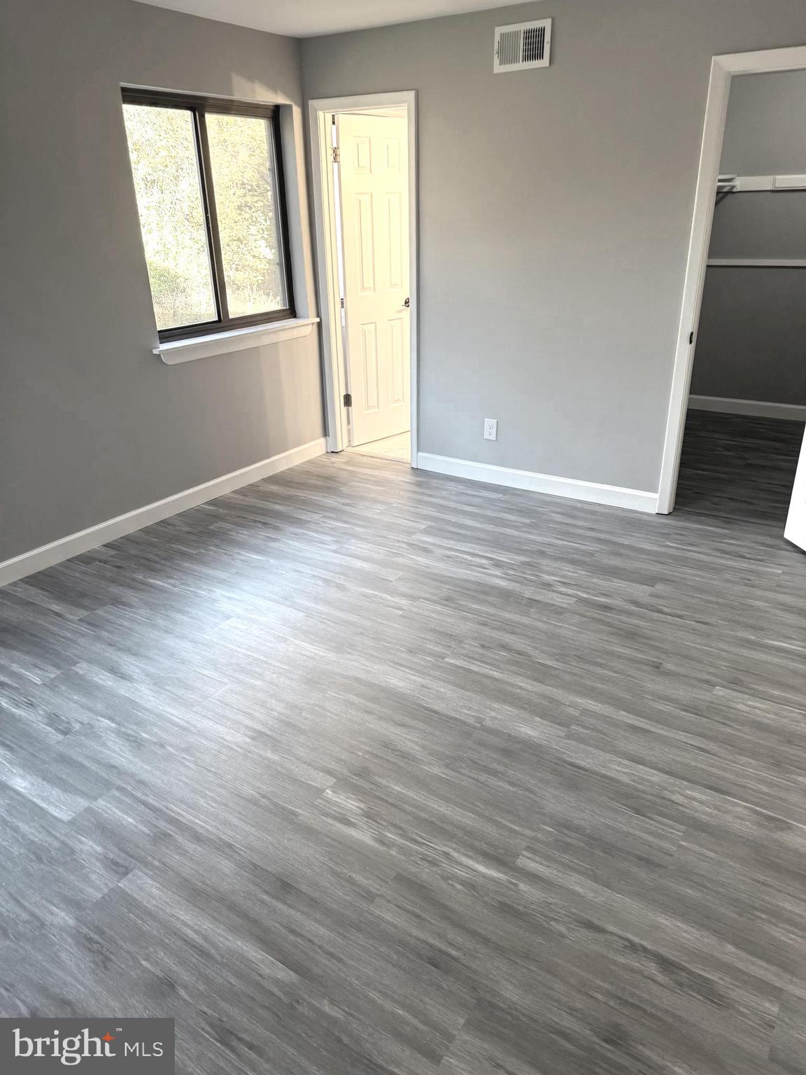 6029 Majors Lane, Unit 4 C16 Columbia, MD 21045 - Photo 2 of 51 an empty room with wooden floor and windows