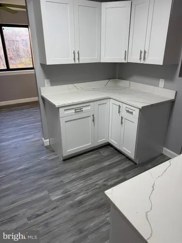 a utility room with wooden floor washer and dryer